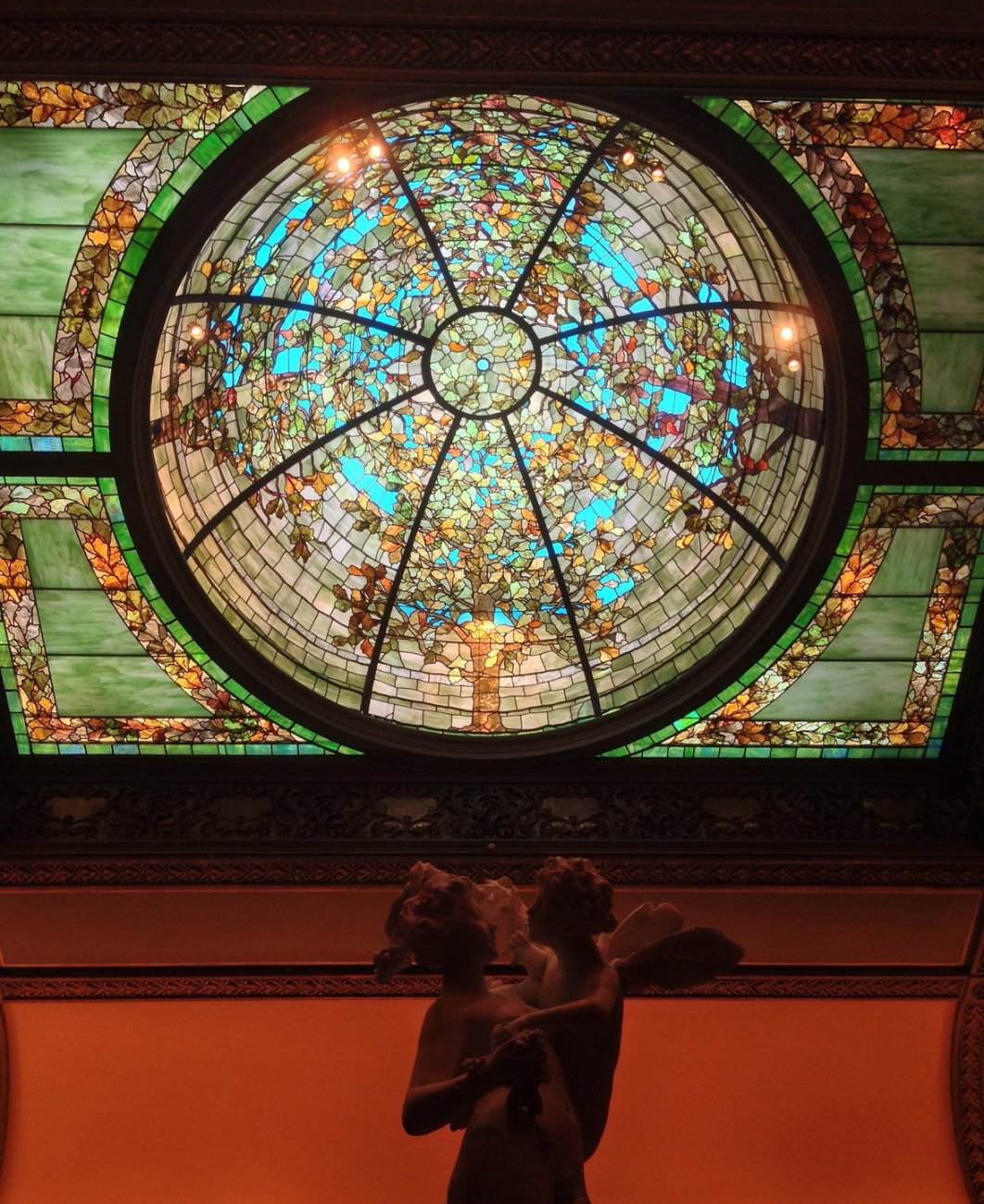 2448px-Sculpture_and_stained_glass_at_Richard_H_Driehaus_museum.jpg